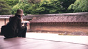 Tourist at Ryoanji Temple's rock garden