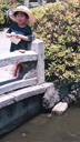 Young girl feeding fish at Kyoto's Shinsen-en garden